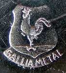 coat of arms with a Gallic cock inside and the inscription below GALLIA METAL